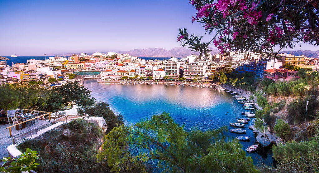 Bay surrounding by plants and buildings in Crete