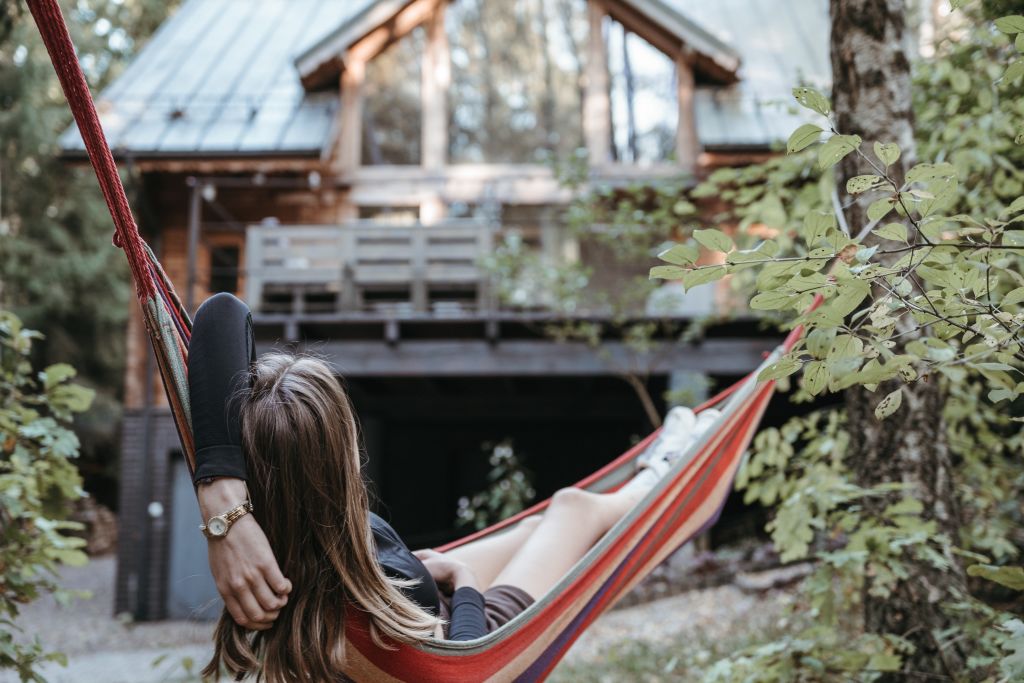 woman in hammock in front of a rental home