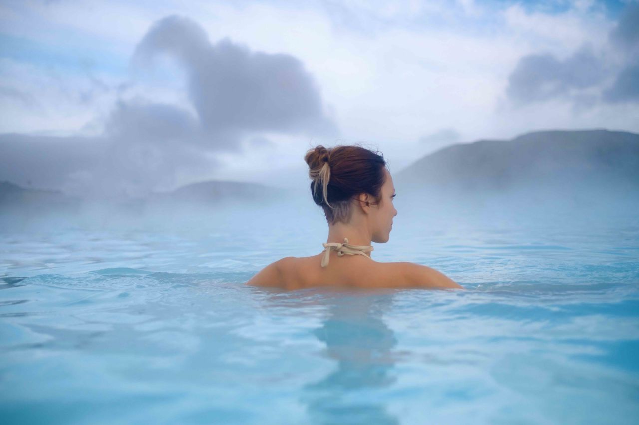 woman bathing in hot spring in iceland