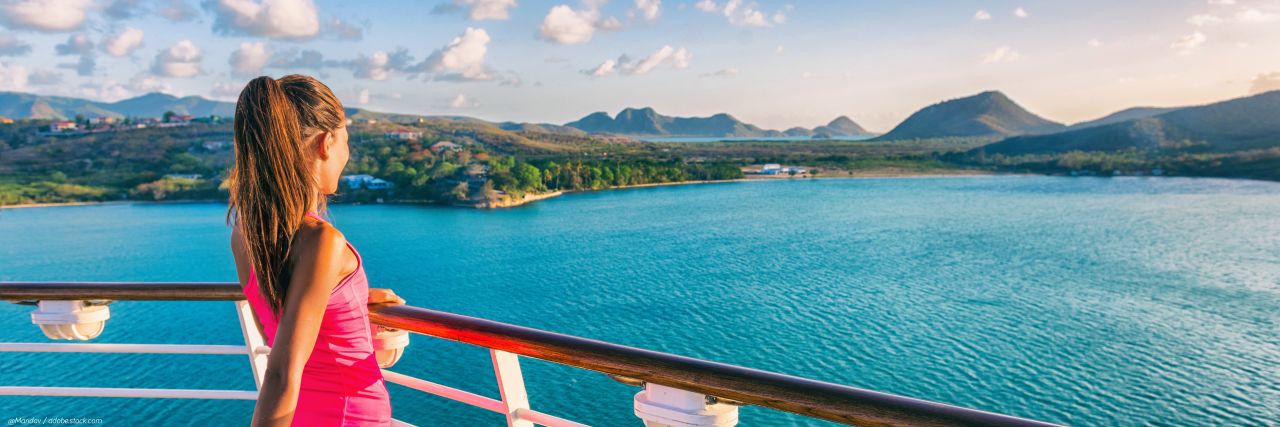 A woman looking over the edge of a cruise boat