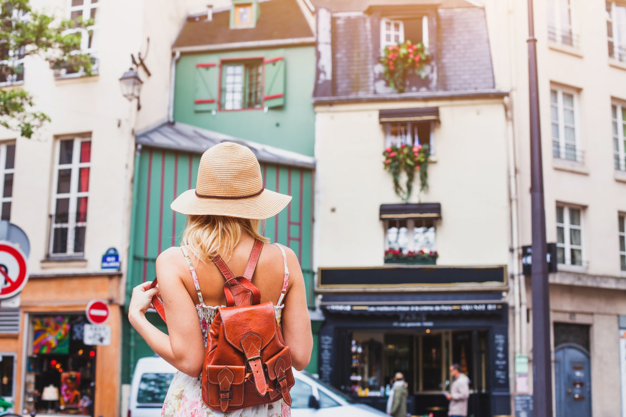 A woman walking around a neighbourhood in Paris