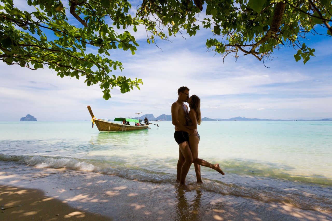 A couple kissing on a beach in Thailand