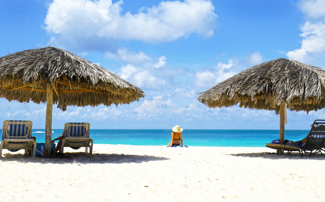Woman sitting on Aruba beach
