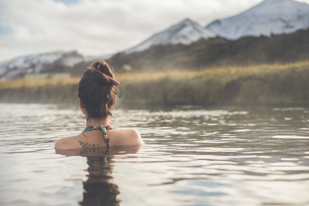 Woman bathing in a hot spring in Iceland