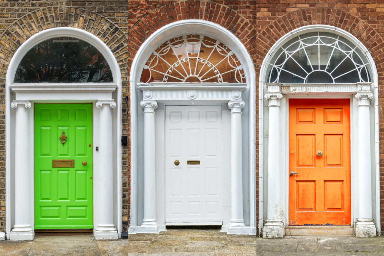 Three doorways in Ireland coloured green, white and orange, like the Irish flag