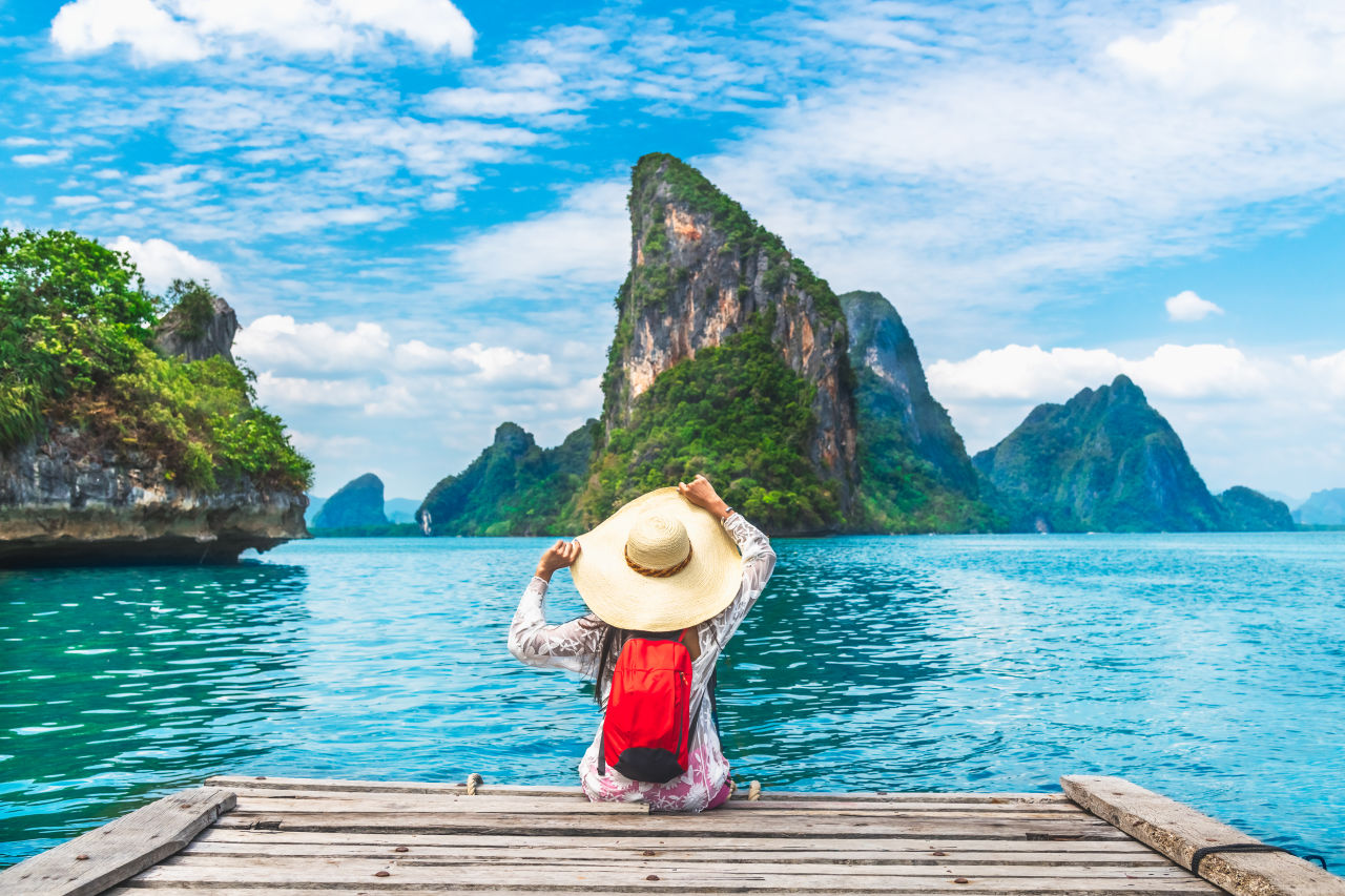 A woman sitting on a boat by the ocean
