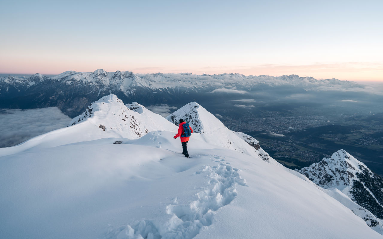 Person on top of snowy mountain