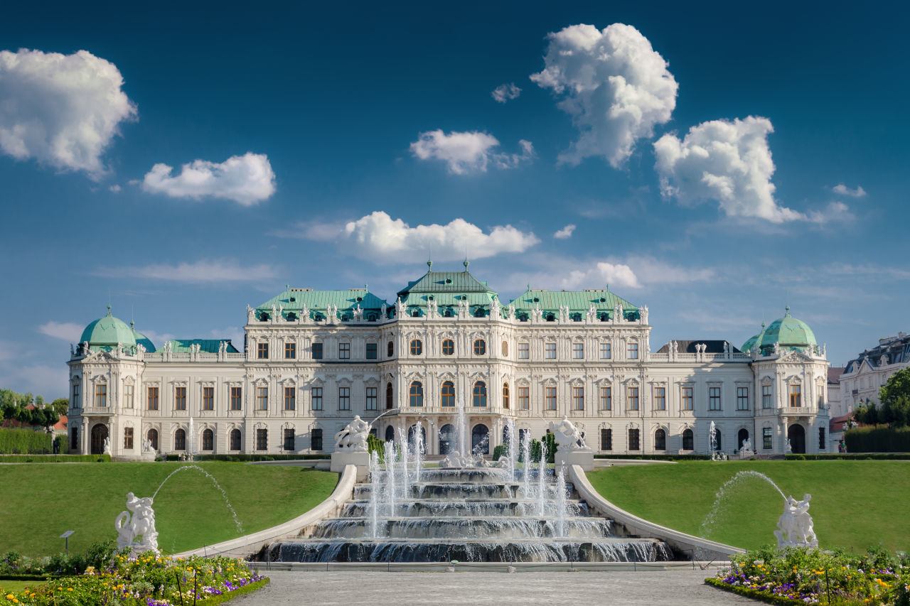 Schönbrunn Palace with blue skies and a fountain above