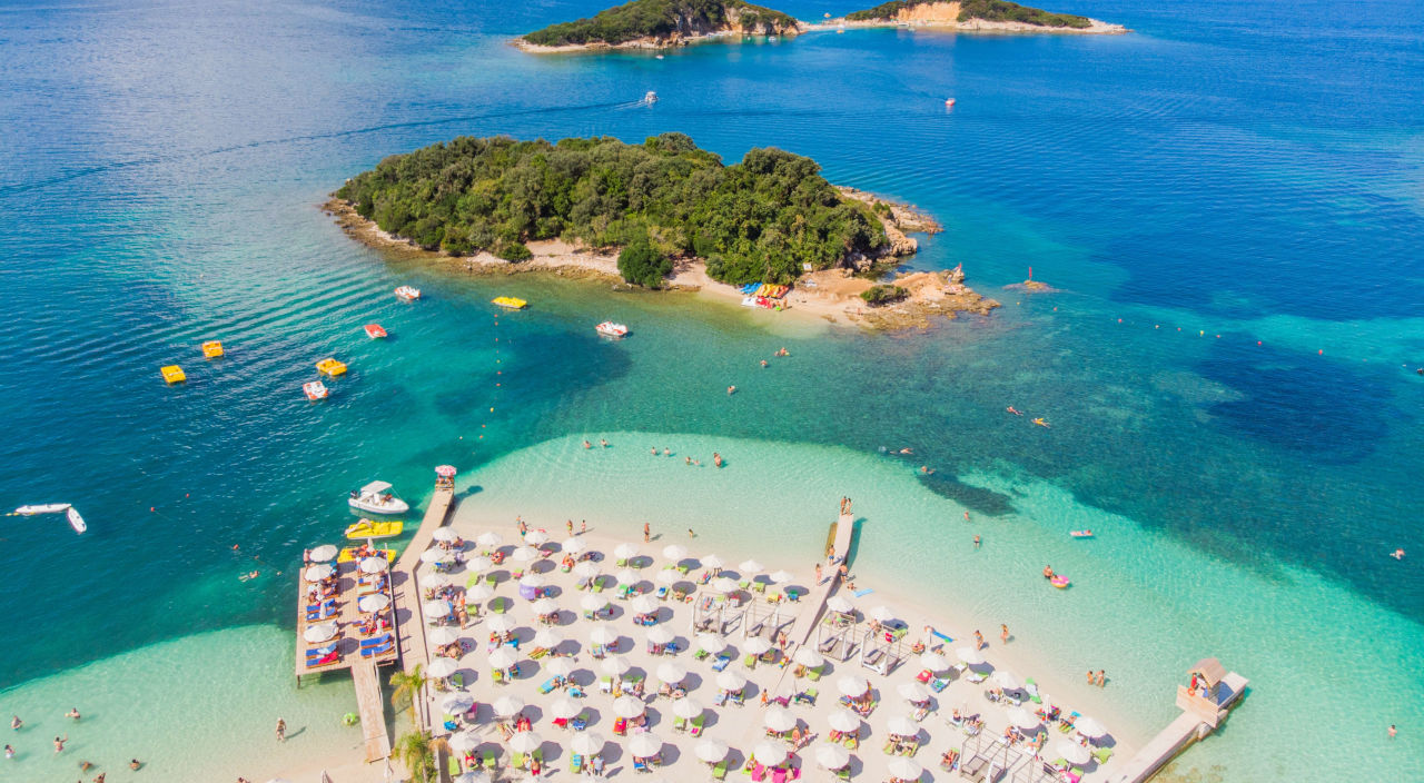 Beach with chairs surrounded by blue ocean water