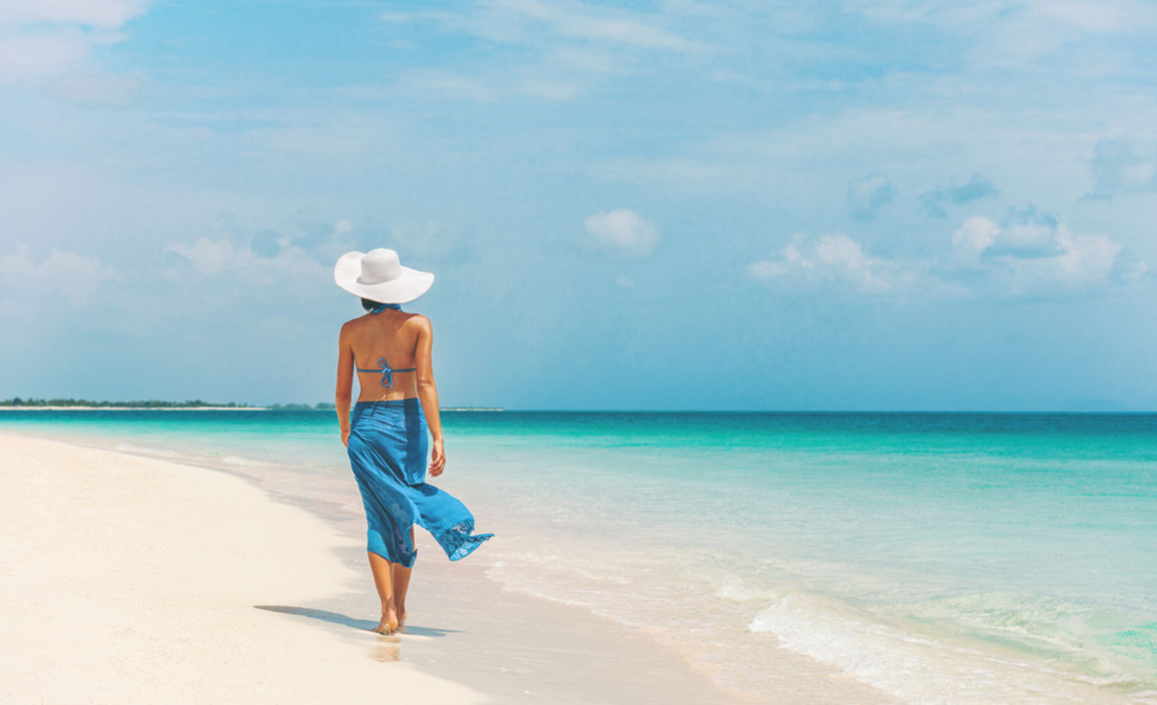 Woman walking on beach in Bermuda