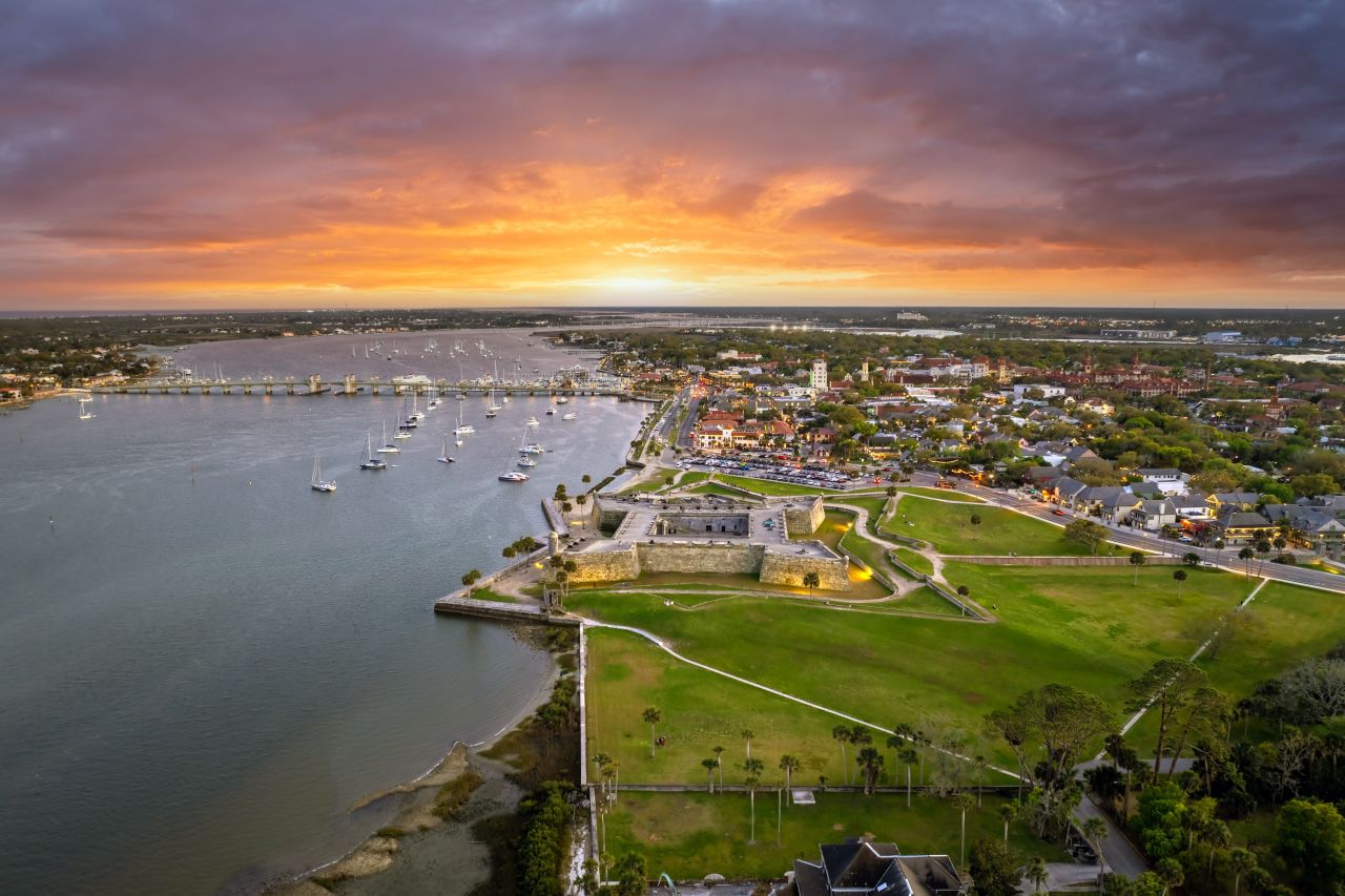 sun setting over an old fort by the ocean in St. Augustine
