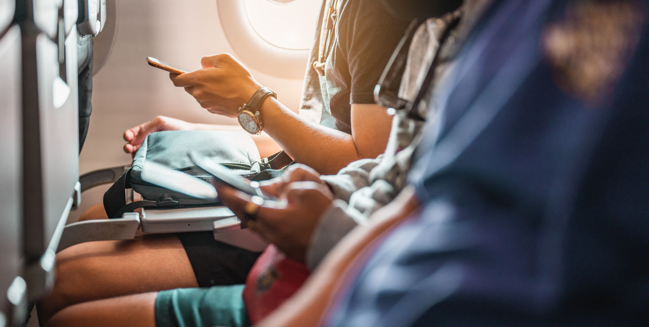 passengers using devices with internet on plane