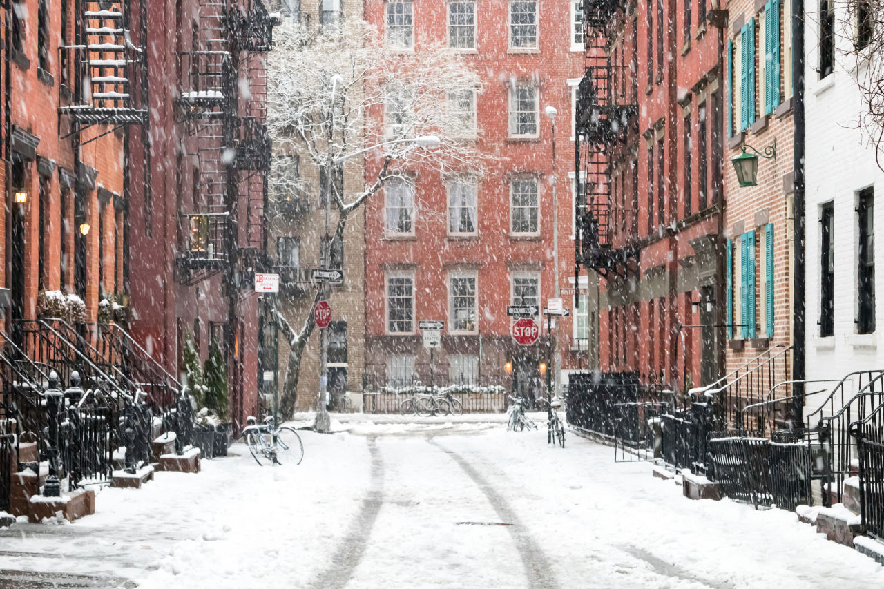 Snow falling heavily on a New York City brownstone street during Northeast blizzard conditions