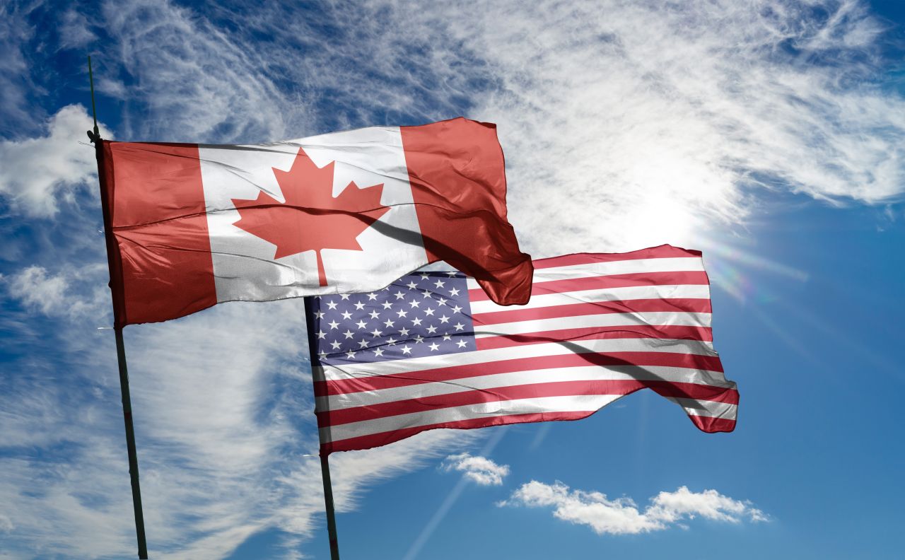 Canadian Travel to the U.S. Is Down 35% and Showing No Signs of Stopping - American and Canadian Flag side by side
