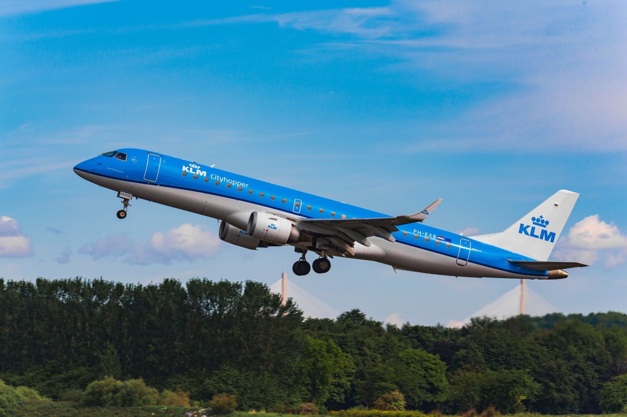 KLM Cityhopper plane taking off from runway amid rising fuel costs and flight cancellations 