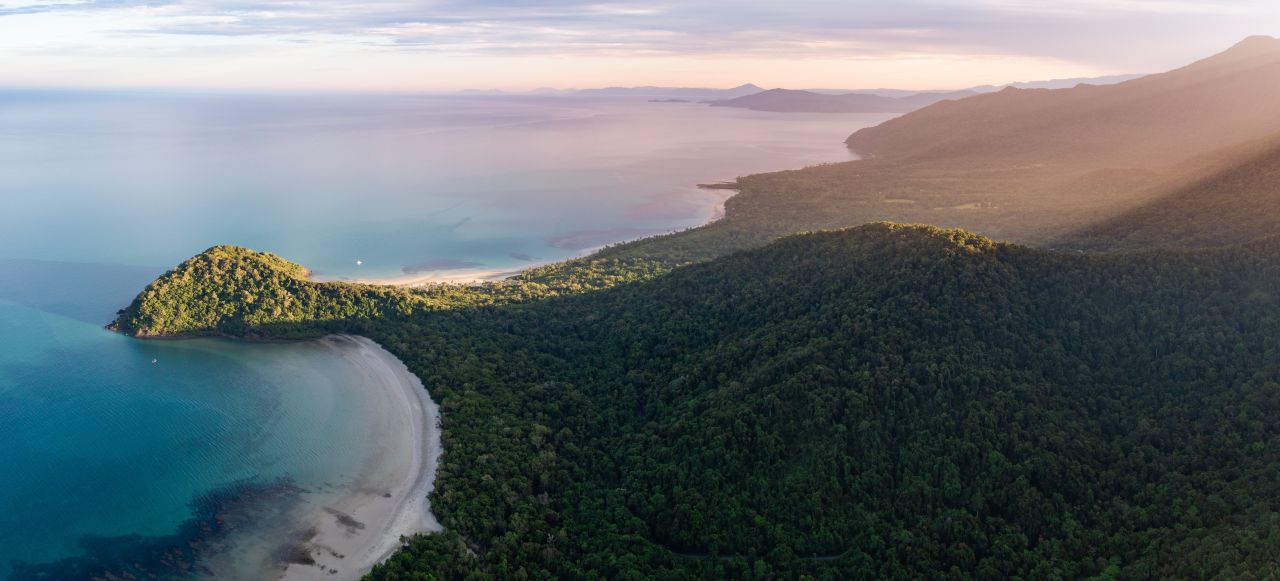 erial view of a tropical beach and turquoise waters along the Daintree Rainforest coastline in Queensland, Australia
