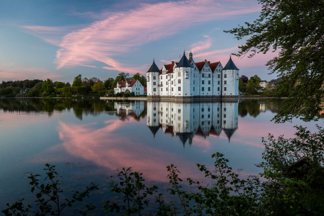 Glücksburg surrounded by water and blue and pink skies