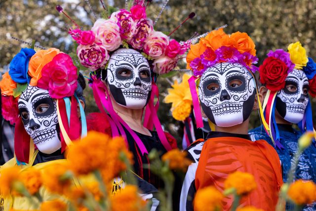 people dressed in skeleton masks for Day of the Dead