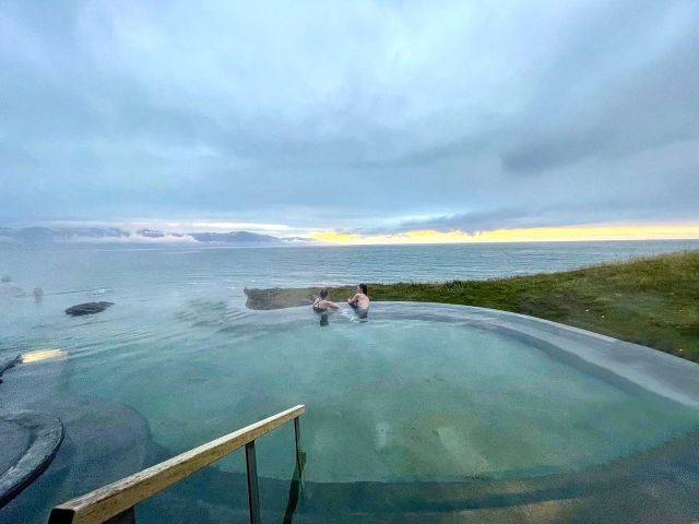couple floating in pool at GeoSea in Husavik