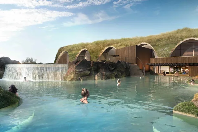 woman in hot spring with waterfall in Iceland called Laugarás