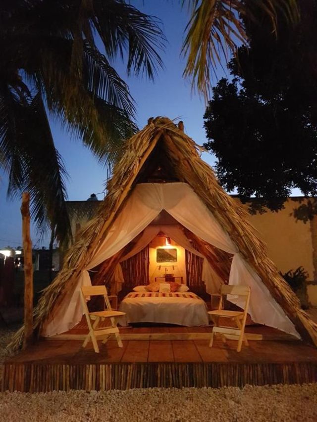 inside of glamping tent lit up at night