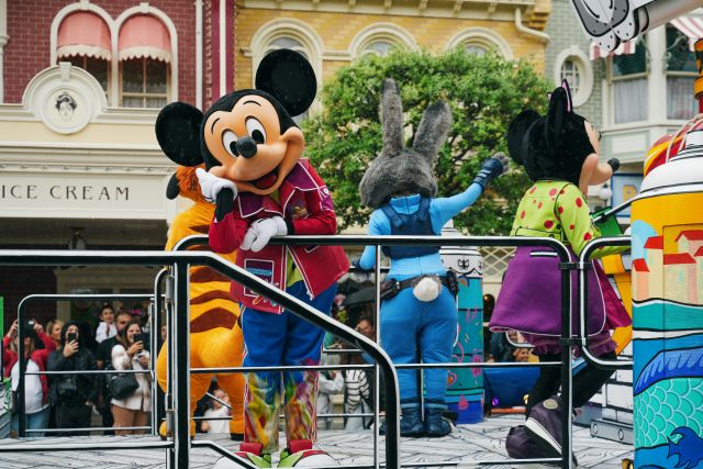 Watch the Disney characters parade through the park