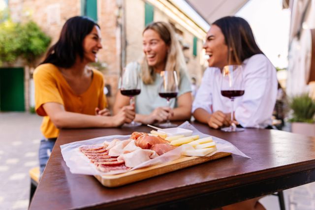 group of women drinking and eating together in Spain