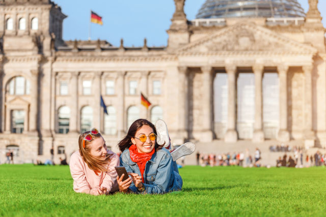 Two girls on grass in Berlin Germany