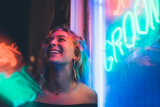 A girl stands outside a nightlife venue