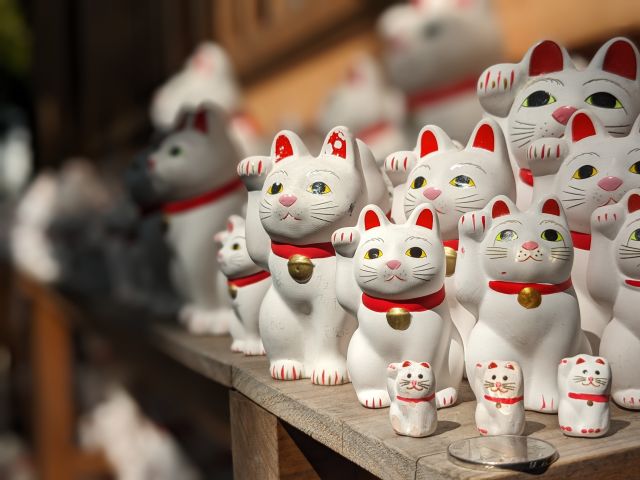 a dozen white waving cats in Japan