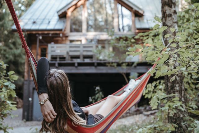 woman in hammock in front of a rental home