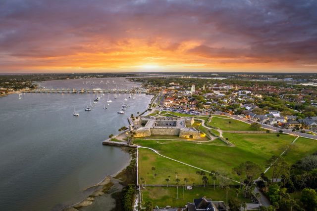 sun setting over an old fort by the ocean in St. Augustine