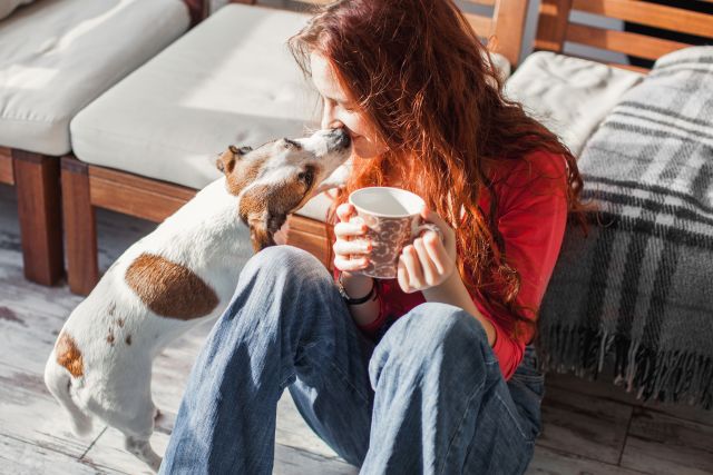 woman drinking coffee with her dog