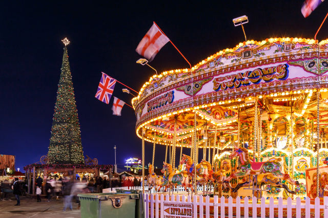 ferris wheel in front of christmas tree in Hyde Park