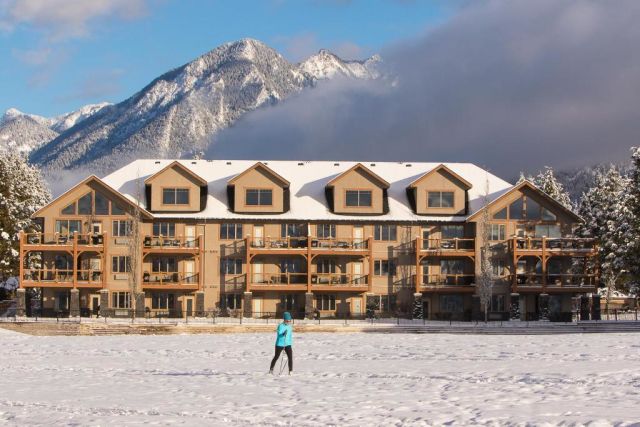 woman walking in snow in front of Bighorn Resort
