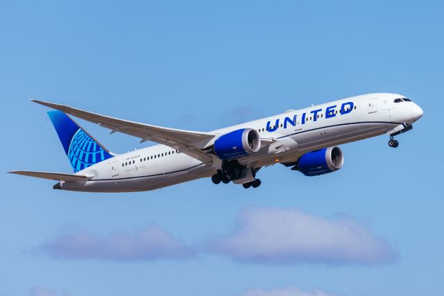 united airlines plane in flight, United Airlines Just Made It Official — No Headphones Could Mean a Permanent Ban