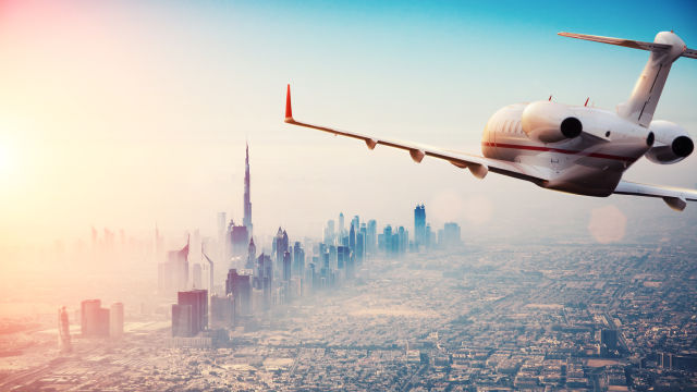 plane flying over Dubai - Dubai Airport Is Open Today — Flights Are Moving and Here's What Travelers Need to Know