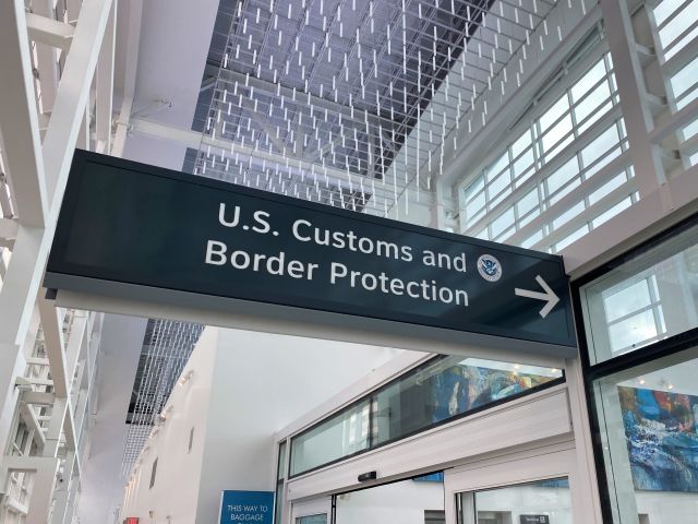 U.S. Customs and Border Protection sign at an airport as travelers face possible new ESTA screening rules.