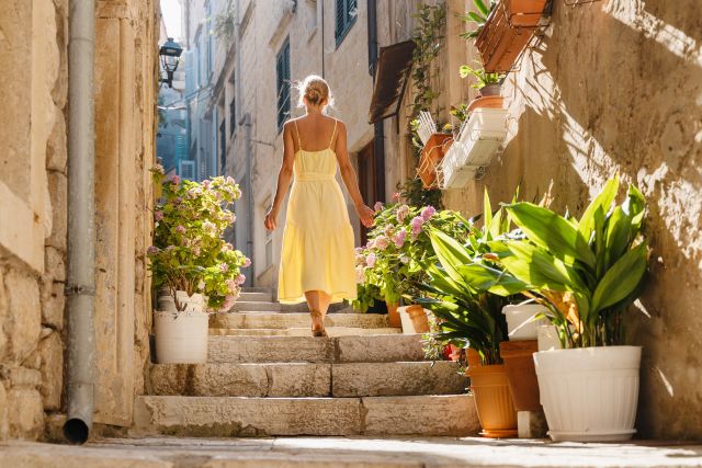 woman walking down a path in Italy