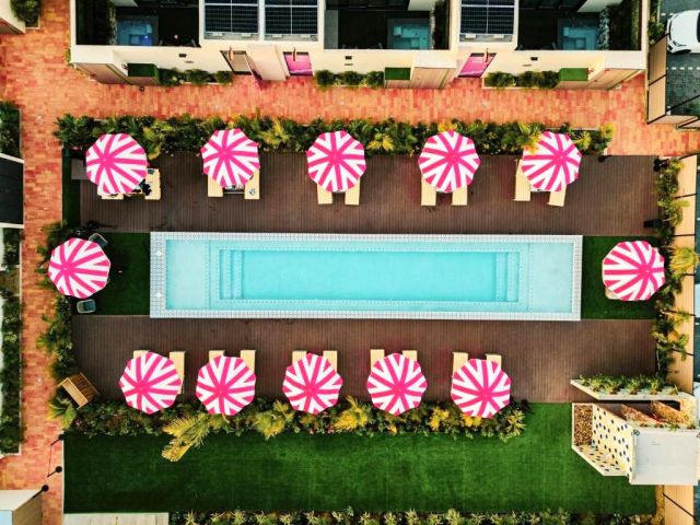 Aruba pool with pink umbrellas