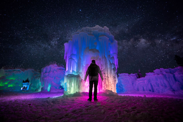 Color-changing LED lights turn the hand-built ice towers at Ice Castles into a glowing light show under the stars