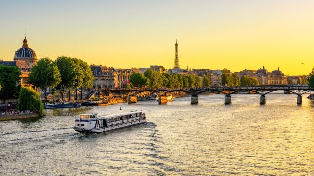 Sunset over the Seine River in Paris with the Eiffel Tower and Pont des Arts