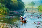A small boat cruises down the river in Vietnam